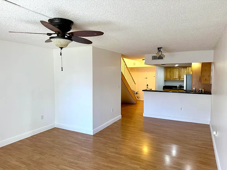 Living room looking into dining and kitchen