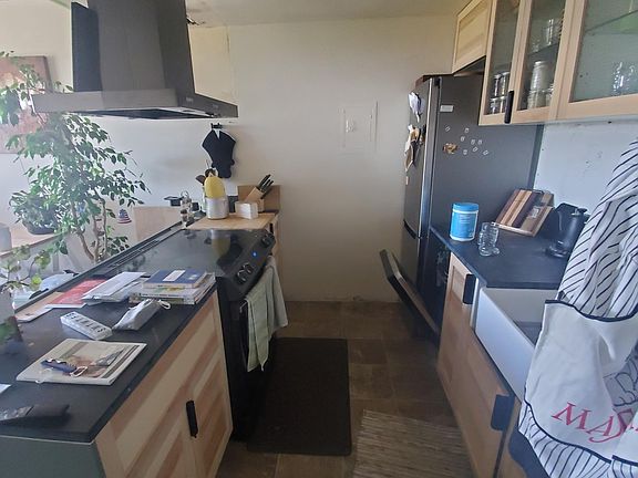 Upgraded kitchen with a farm house sink, open concept, and stainless steel appliances.