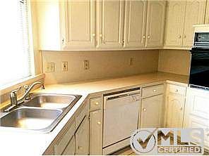 A cute kitchen with built in microwave, wall oven and more has t