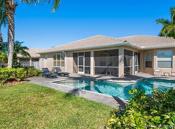 Lovely open pool and patio with a screened and shaded patio area also.