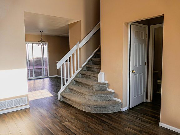 Entry way and Front Room is full of light with large windows and vaulted ceilings