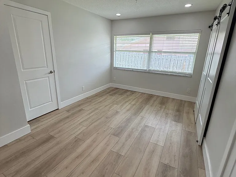 Dining area off kitchen, Primary bedroom to left, laundry area to right