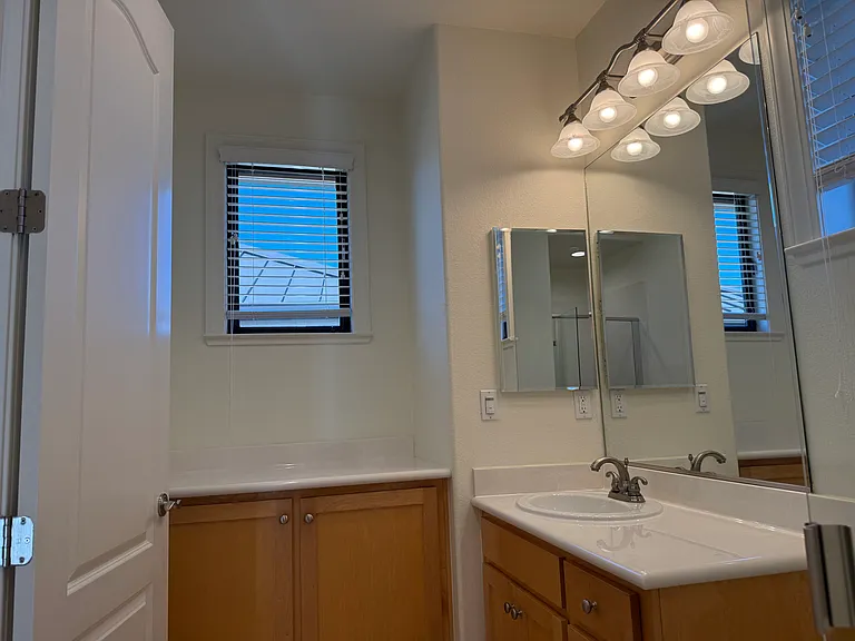 Third floor hallway bathroom features a shower stall and a storage cabinet.