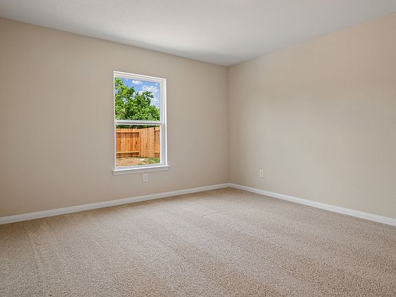 Master bedroom with lush carpet flooring