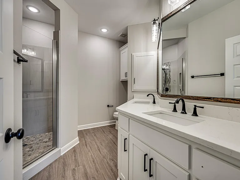 Master shower and linen cabinets for added storage