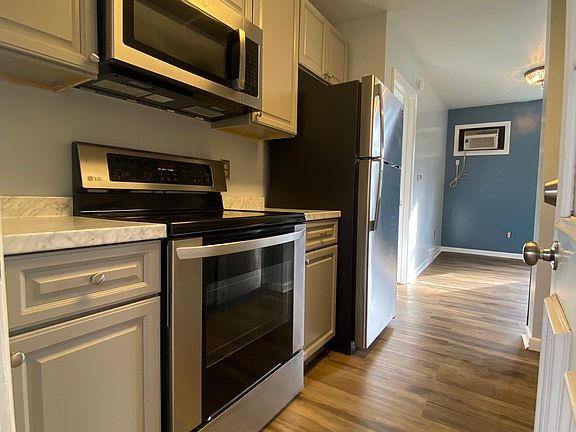 Kitchen with microwave above stove.