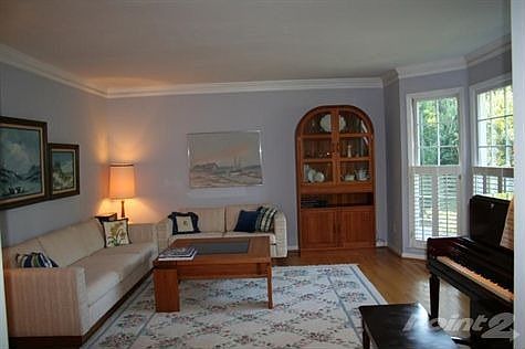 Formal living room with hardwood floors and bay window
