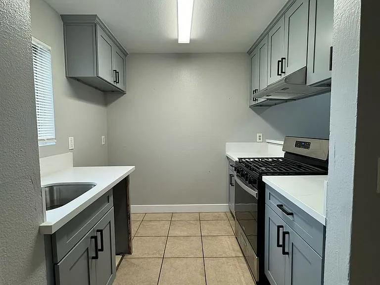 Beautifully renovated kitchen with quartz countertops.