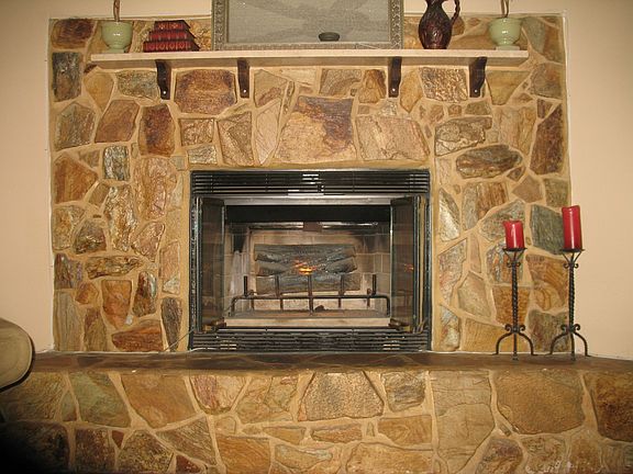 wood-burning, stone fireplace with seating area