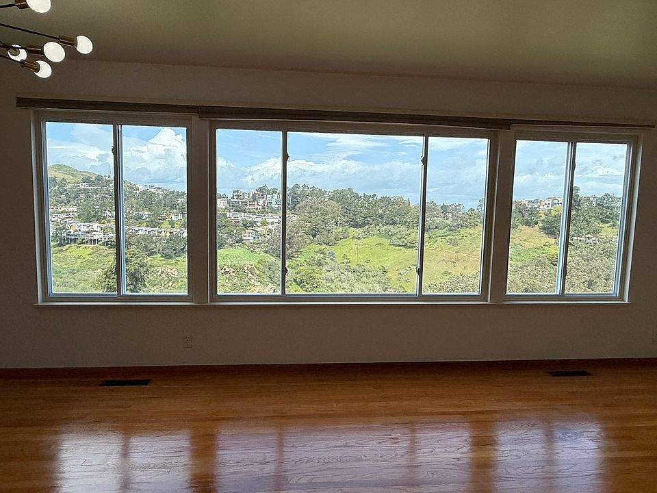 View from living space. Left to right: Twin Peaks, Diamond Heights, Salesforce tower, Glen Park and Glen Canyon Park. O'Shaughnessy Blvd and O'Shaughnessy Hollows directly below.