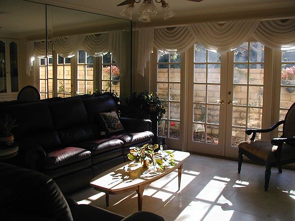 Living room with lots of mirrors and a view of the roses