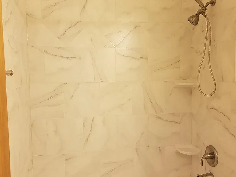 guest bathroom
tile is the same as in master bath, lighting makes it look darker.