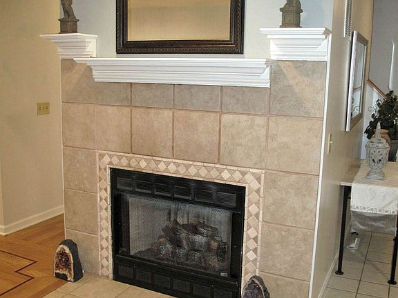The GAS FIREPLACE has been retiled and is a lovely focal point for the light & bright LIVING ROOM.