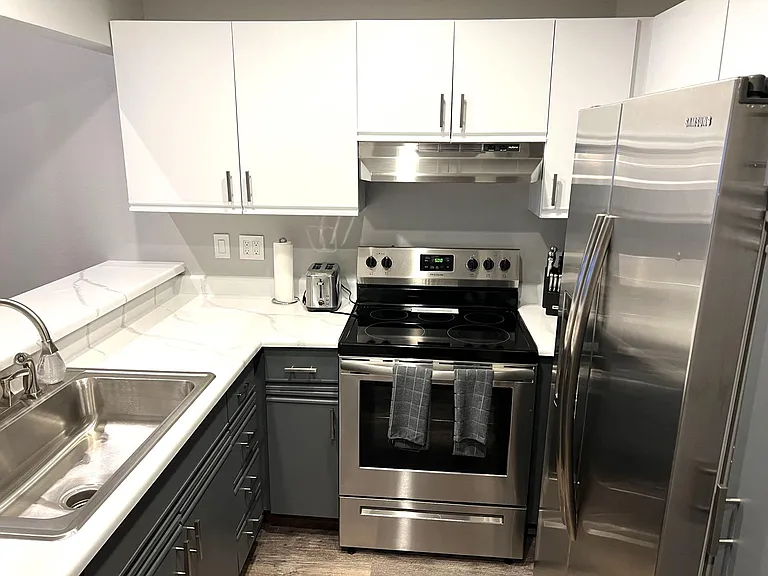 Kitchen with bar with seating for four, stainless appliances, refrigerator with filtered water and ice maker in door, Bosch quiet dishwasher