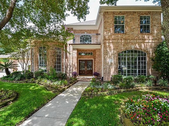 Three car garage and wide driveway make parking easy for multiple family members. Brick facade is pretty and low maintenance. Full sprinkler system works to keep the gardens lush and colorful.
