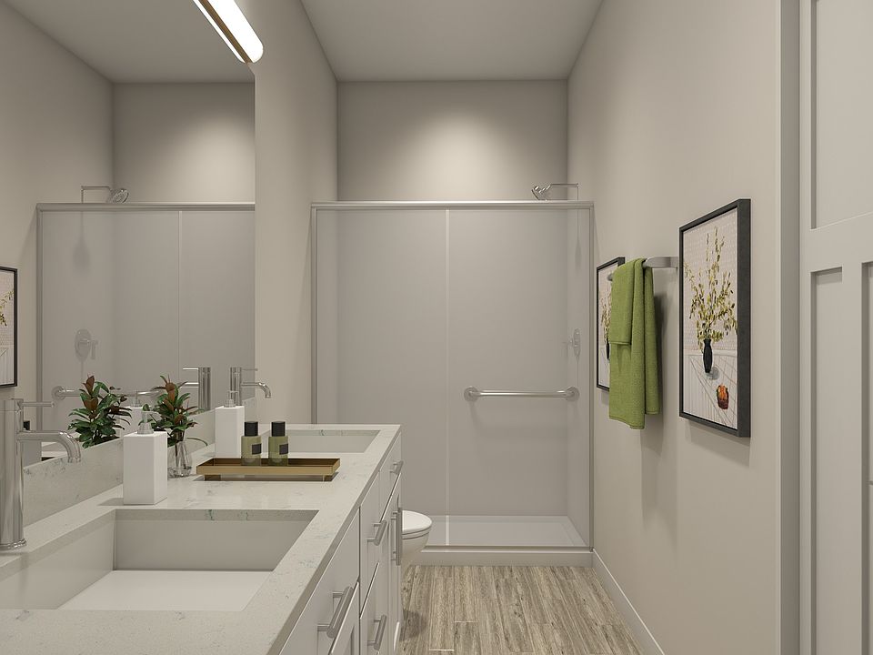 Flats at Sugar Run Delaware Ohio apartments showing a bathroom with dual sink and walk-in shower.