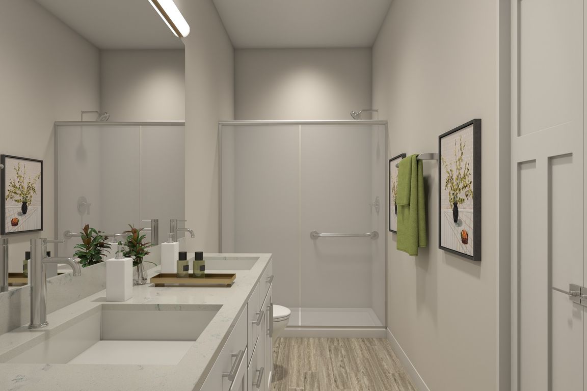 Flats at Sugar Run Delaware Ohio apartments showing a bathroom with dual sink and walk-in shower.
