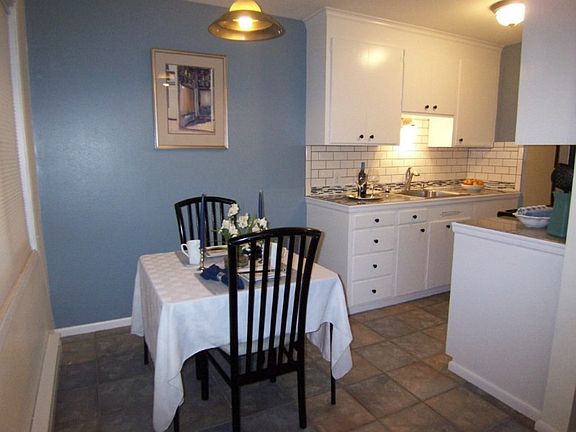 Dining area off updated kitchen. Lovely tile work on floors and countertops/backsplash.
