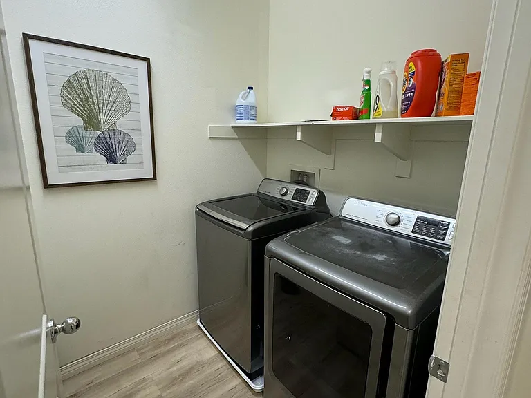 Laundry room located off upstairs hallway