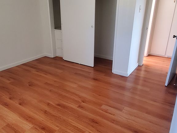 Laminate wood flooring. Window AC in bedroom.