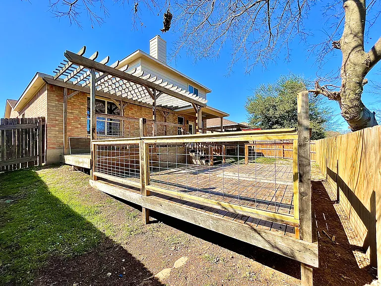 Backyard comes with two large wooden decks and a pergola patio