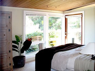 One of three bedrooms, this one opening onto a central deck with Bay views.