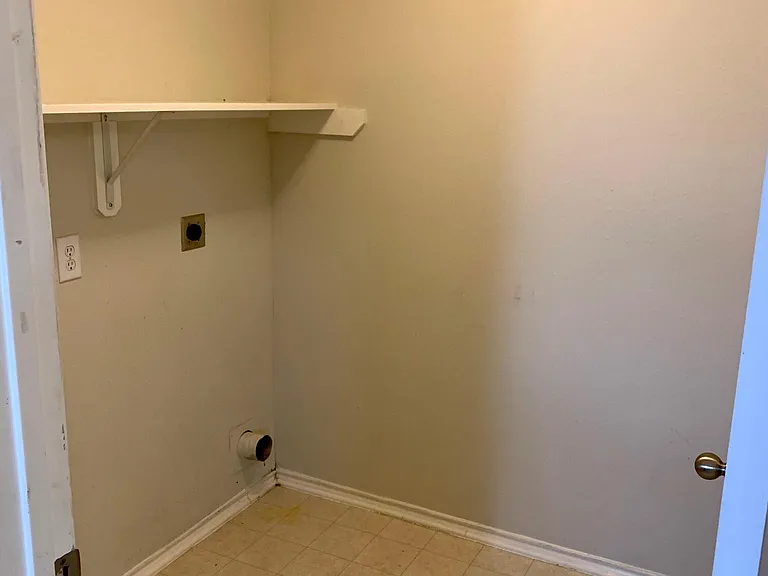 Laundry Room has extra room for storage or shelving.