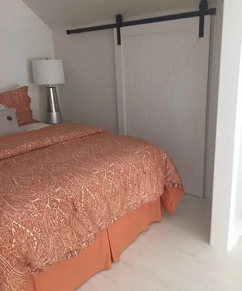 Closet with hanging space and shelves for storage.