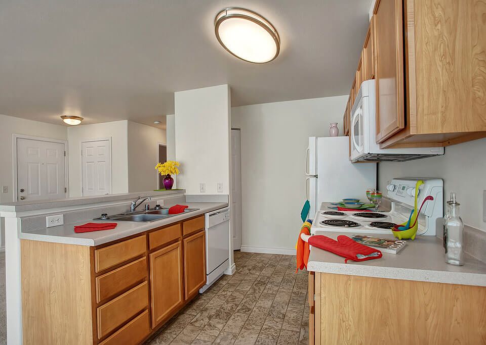 A kitchen with plenty of counter space, a breakfast bar, and lots of cabinet storage space