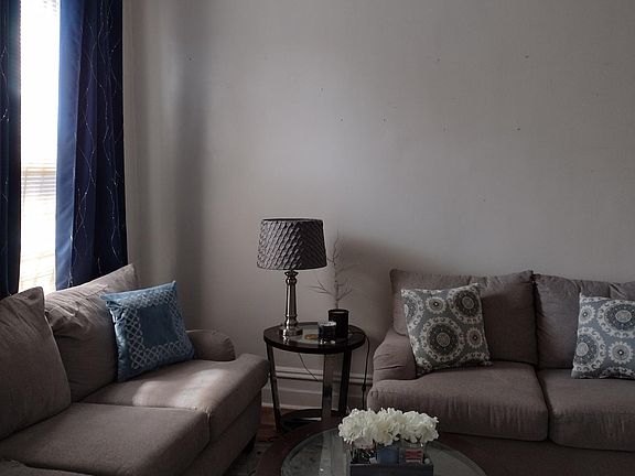 You enter into a large living room area. To the left is the dining room and kitchen. To the right is bath and bedroom