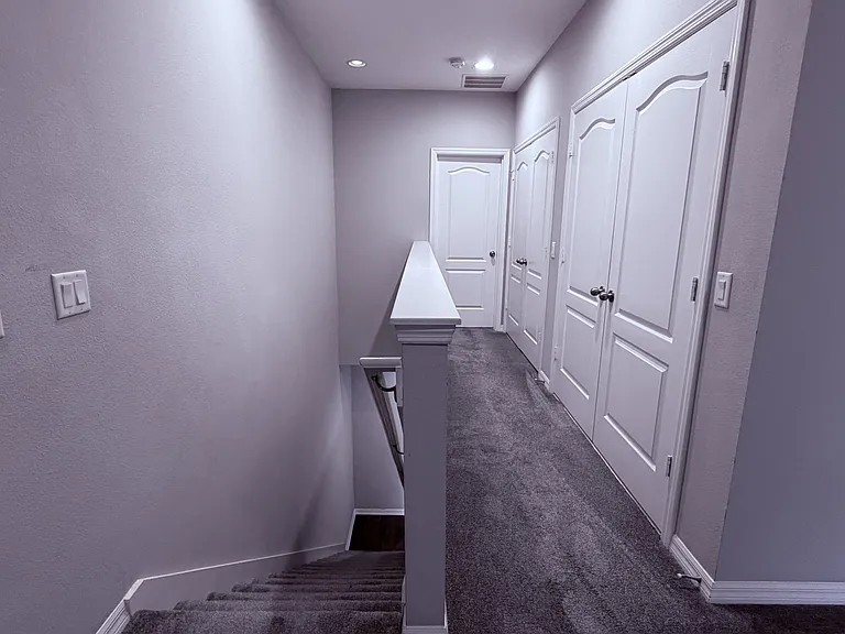 Loft view shows staircase, master suite passage, laundry, and linen closets.