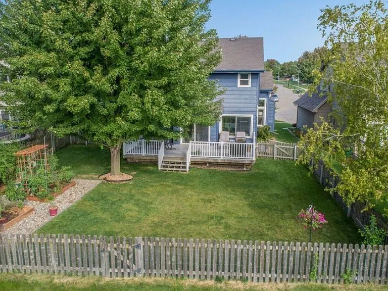 Backyard with shade on the deck plus a raised garden area