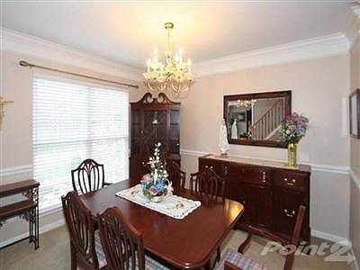Freshly painted formal dining room with crown molding, chair rail and chandelier.