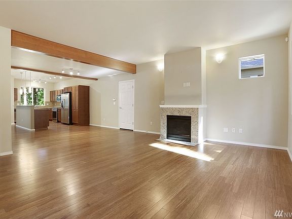 Upon entering you'll find a bright and spacious living room, boasting a gas fireplace with granite tile surround and sconce lighting.