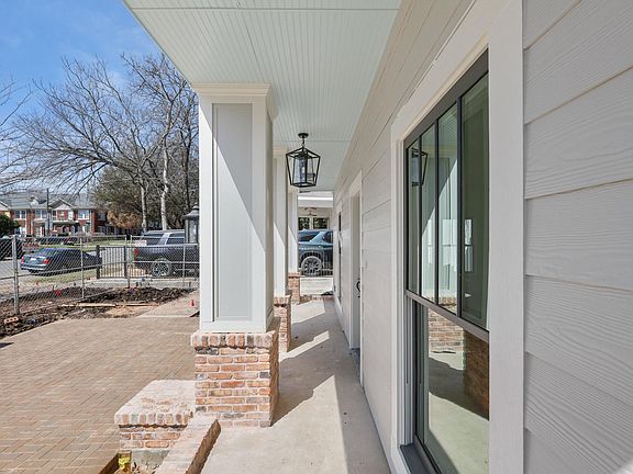 Inviting courtyard that leads you onto a large front porch