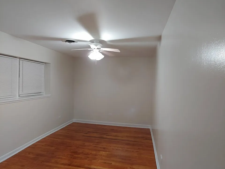 large bedroom with hardwood floors