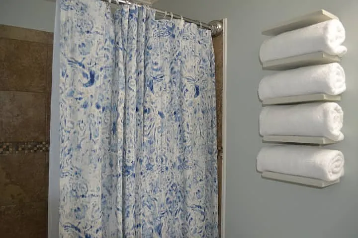 Full bathroom with ceramic shower wall