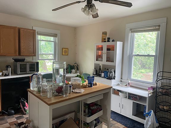 Kitchen view from living room doorway towards sink, dishwasher.