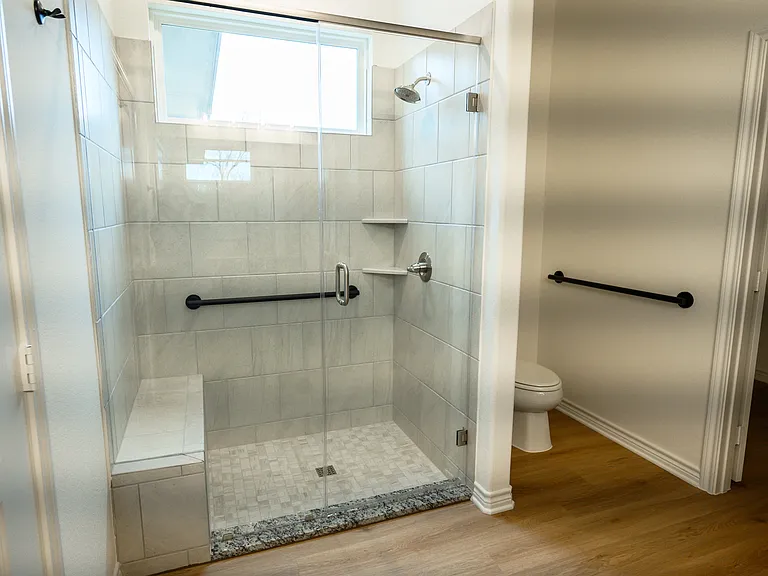 Studio apartment bathroom with grab bars, great for elderly people
