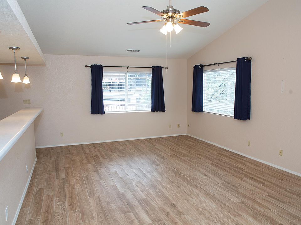 Living room area, renovated flooring, large windows