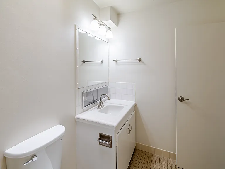 Step into Bathroom A, where a spacious vanity and large mirror create a clean setting.