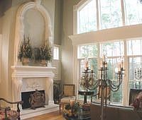 The grand room features a coffered ceiling and soaring fireplace.