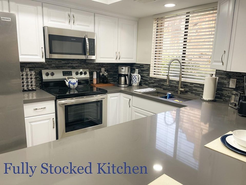 Fully stocked kitchen with dishes and cooking utensils!