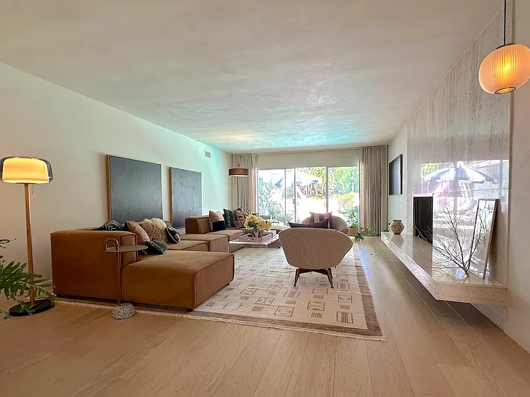 view of formal living room, travertine fireplace and large Samsung gallery frame tv