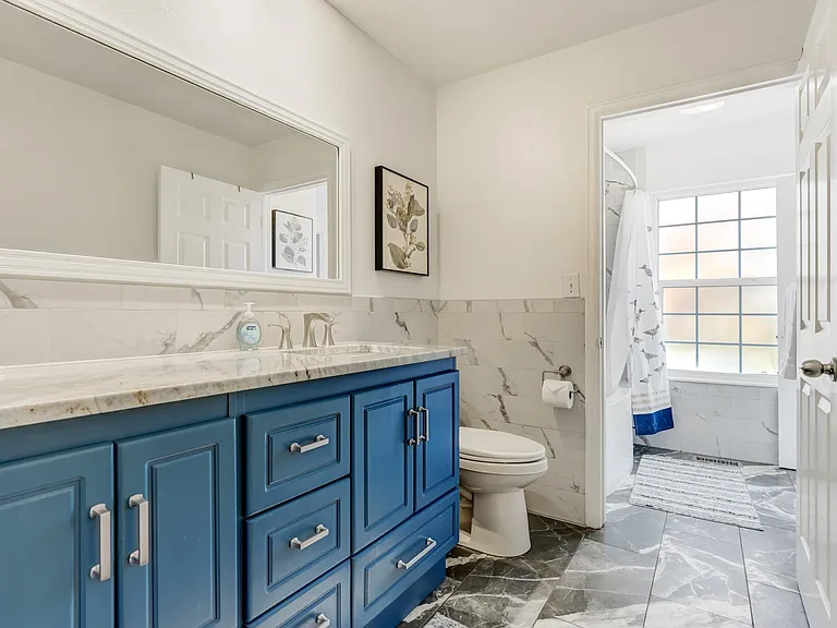 Large full bathroom on the upper level accessible from the hallway and the master bedroom