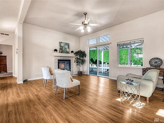 Living room with a gas fireplace and vaulted ceilings.
