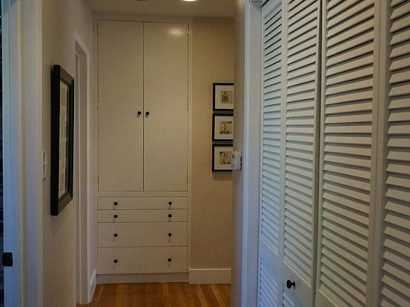 Hallway with closet leading to bedrooms