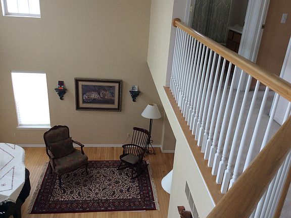 Second floor with custom railing and sweeping views of first floor and foyer