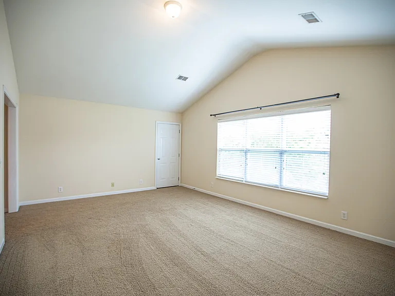he spacious main-level primary suite is a private retreat featuring a large walk-in closet, a spa-inspired en-suite bathroom with a soaking tub, separate walk-in shower, Enjoy direct patio from the bedroom and relax with peaceful wooded and privacy