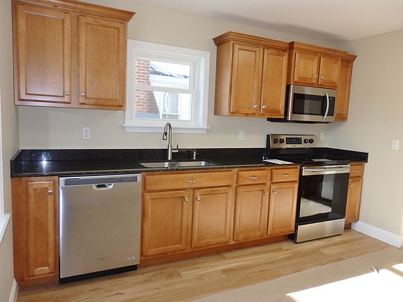 kitchen with dishwasher, granite counters, self-cleaning oven and microwave that vents to the outside